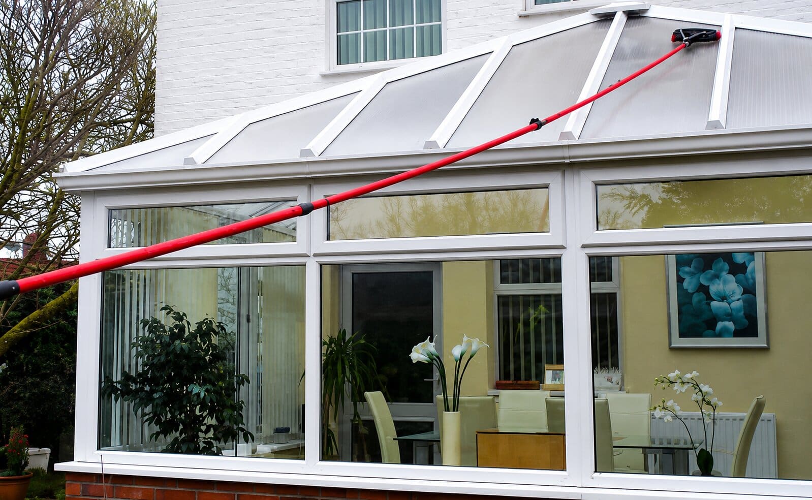 Water-fed pole cleaning a conservatory roof