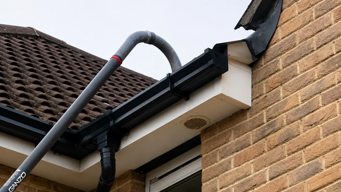 Professional gutter vacuum equipment in use