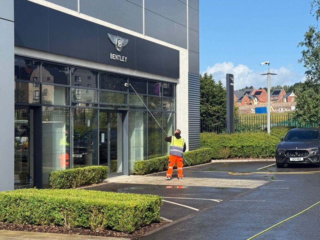 AquaClean operative using an extended pole to clean Bentley showroom windows