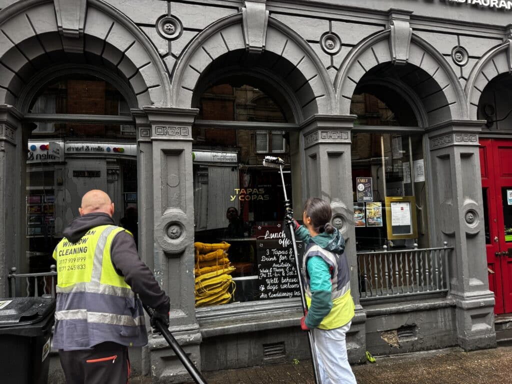 AquaClean team cleaning arched windows at a tapas restaurant